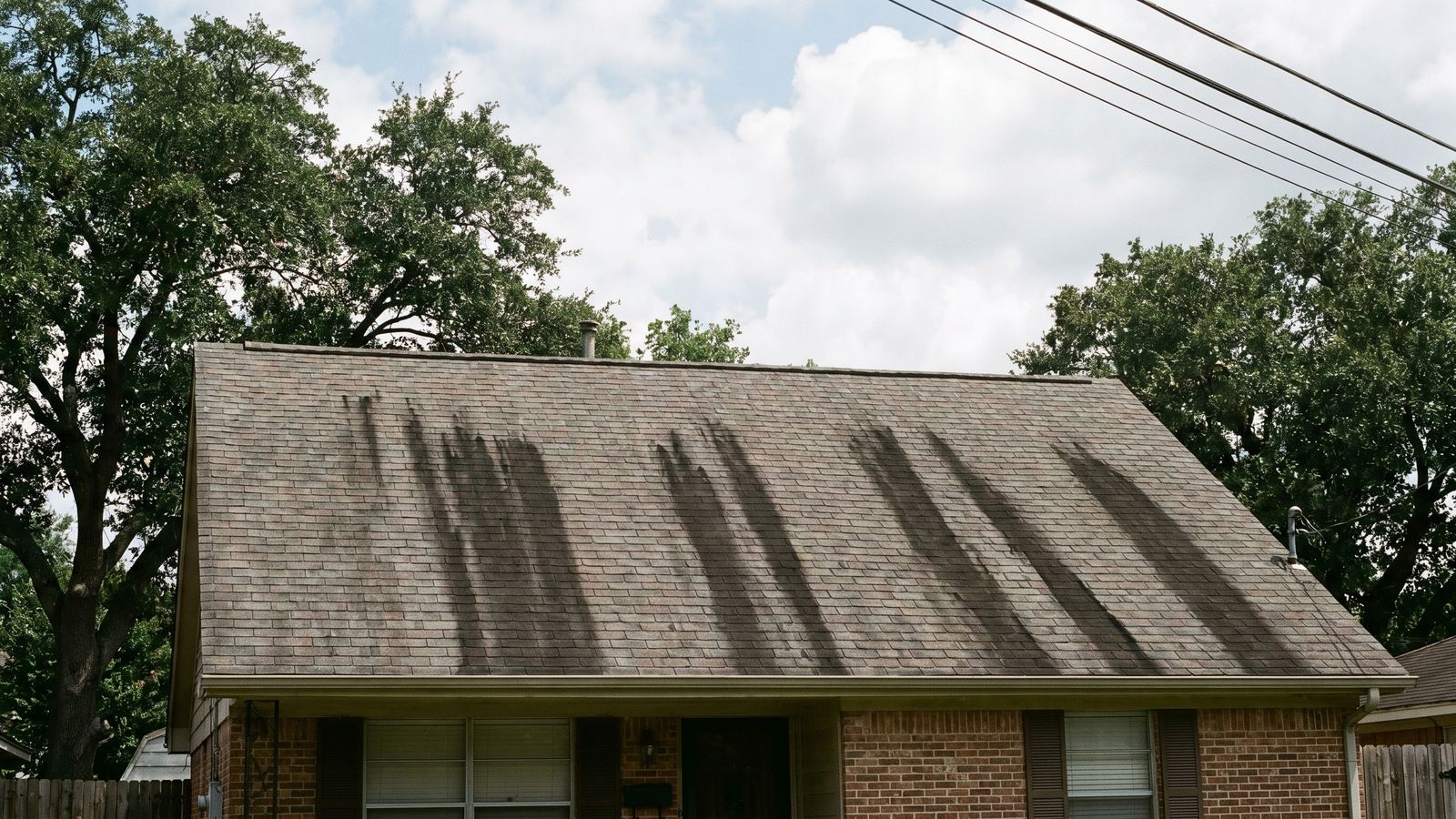 Houston home roof with black algae streaks before B&R soft-wash treatment